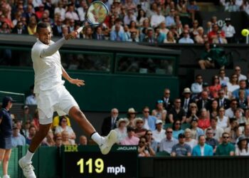 Australia's Nick Kyrgios returns against Spain's Rafael Nadal during their men's singles second round match on the fourth day of the 2019 Wimbledon Championships at The All England Lawn Tennis Club in Wimbledon, southwest London, on July 4, 2019. (Photo by Adrian DENNIS / AFP) / RESTRICTED TO EDITORIAL USE