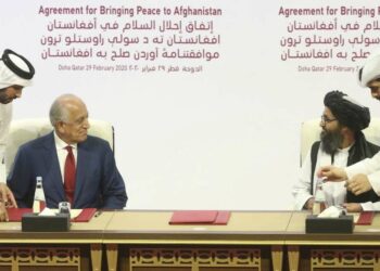 U.S. peace envoy Zalmay Khalilzad, left, and Mullah Abdul Ghani Baradar, the Taliban group's top political leader sign a peace agreement between Taliban and U.S. officials in Doha, Qatar, Saturday, Feb. 29, 2020. The United States is poised to sign a peace agreement with Taliban militants on Saturday aimed at bringing an end to 18 years of bloodshed in Afghanistan and allowing U.S. troops to return home from America's longest war. (AP Photo/Hussein Sayed)