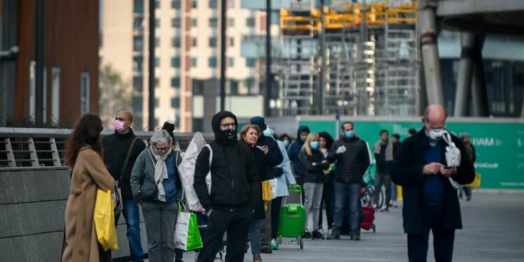 In fila per entrare in un supermercato di Milano (LaPresse)