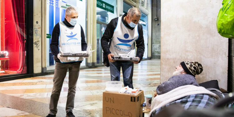 Unità di strada di Progetto Arca distribuisce il pasto caldo a un senza dimora a Milano (foto Daniele Lazzaretto)